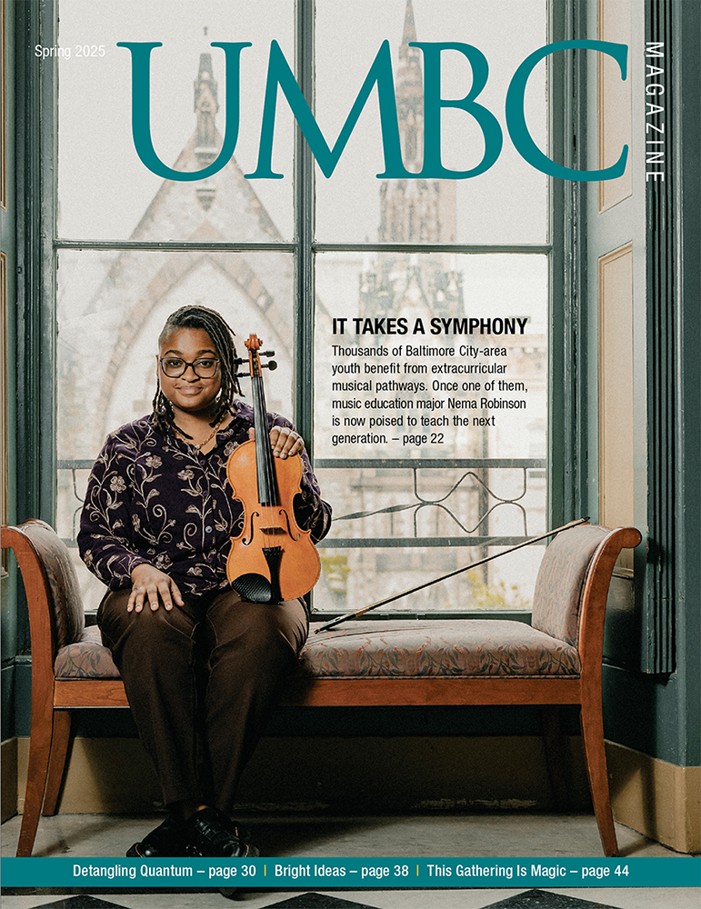 A young black woman holding a violin, sitting in front of a window